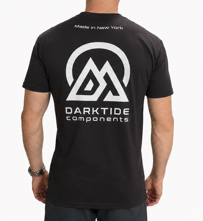 Person wearing a black t-shirt with 'Darktide Components' logo on the back, standing against a white background.