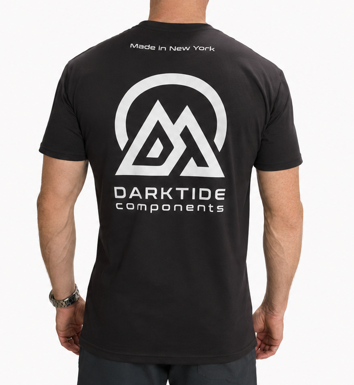 Person wearing a black t-shirt with 'Darktide Components' logo on the back, standing against a white background.